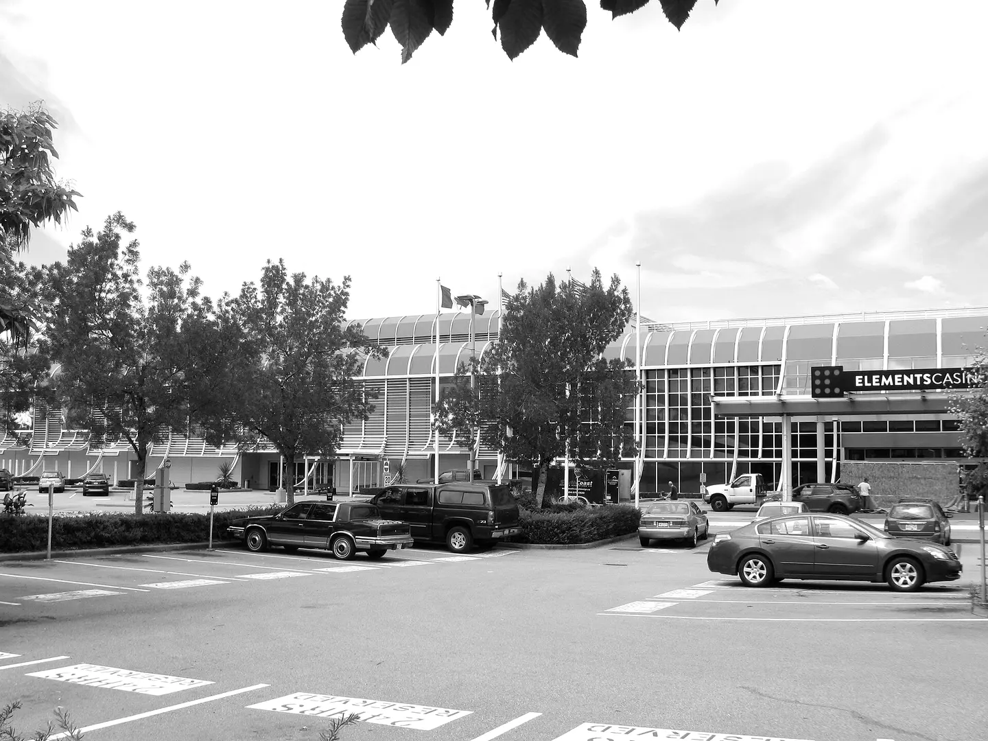 The Elements Casino Surrey building on 60 Avenue with its curved roof, seen across the parking lot