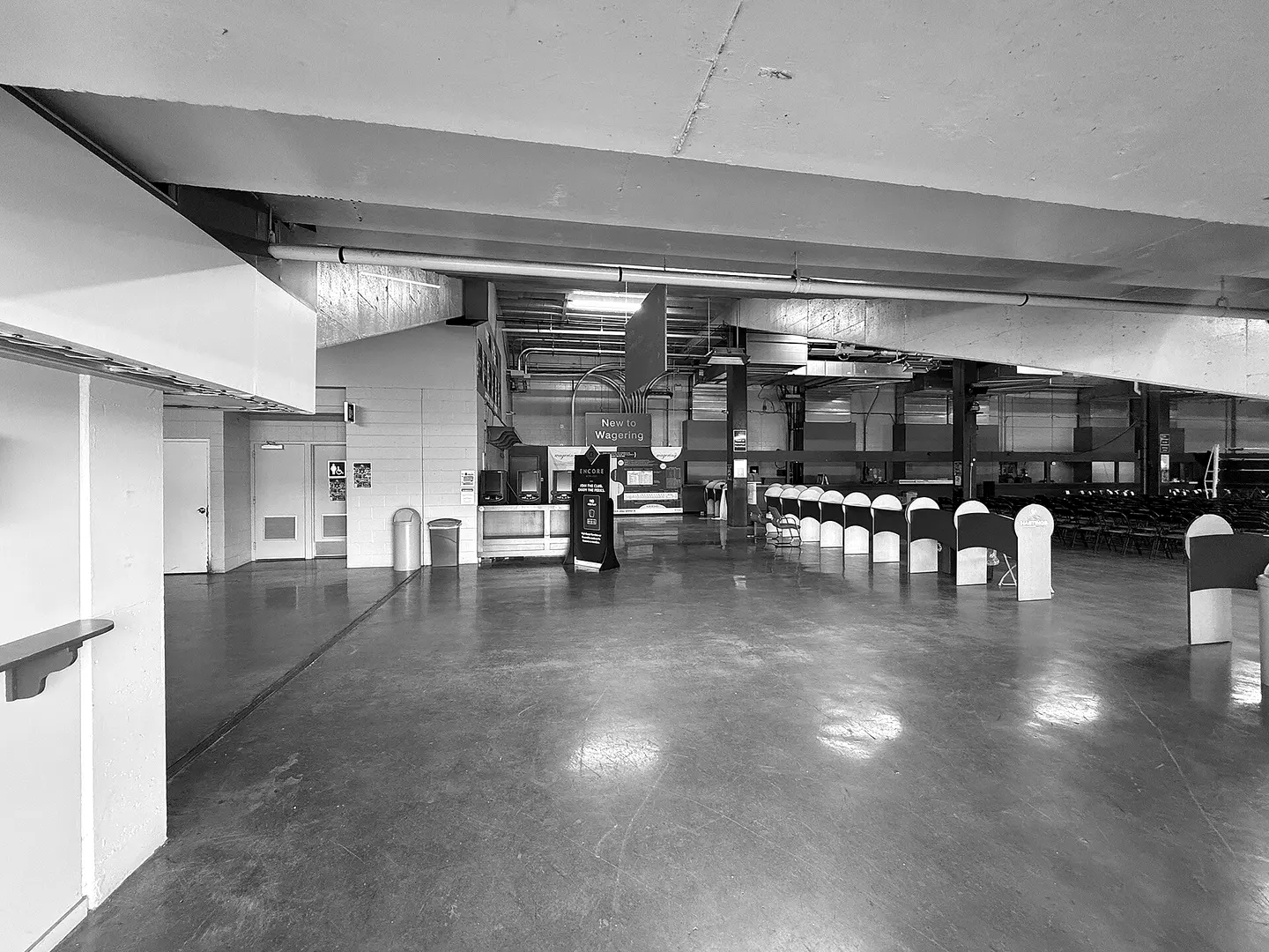 Inside the Hastings grandstand: a long hall with betting counters and rows of seats